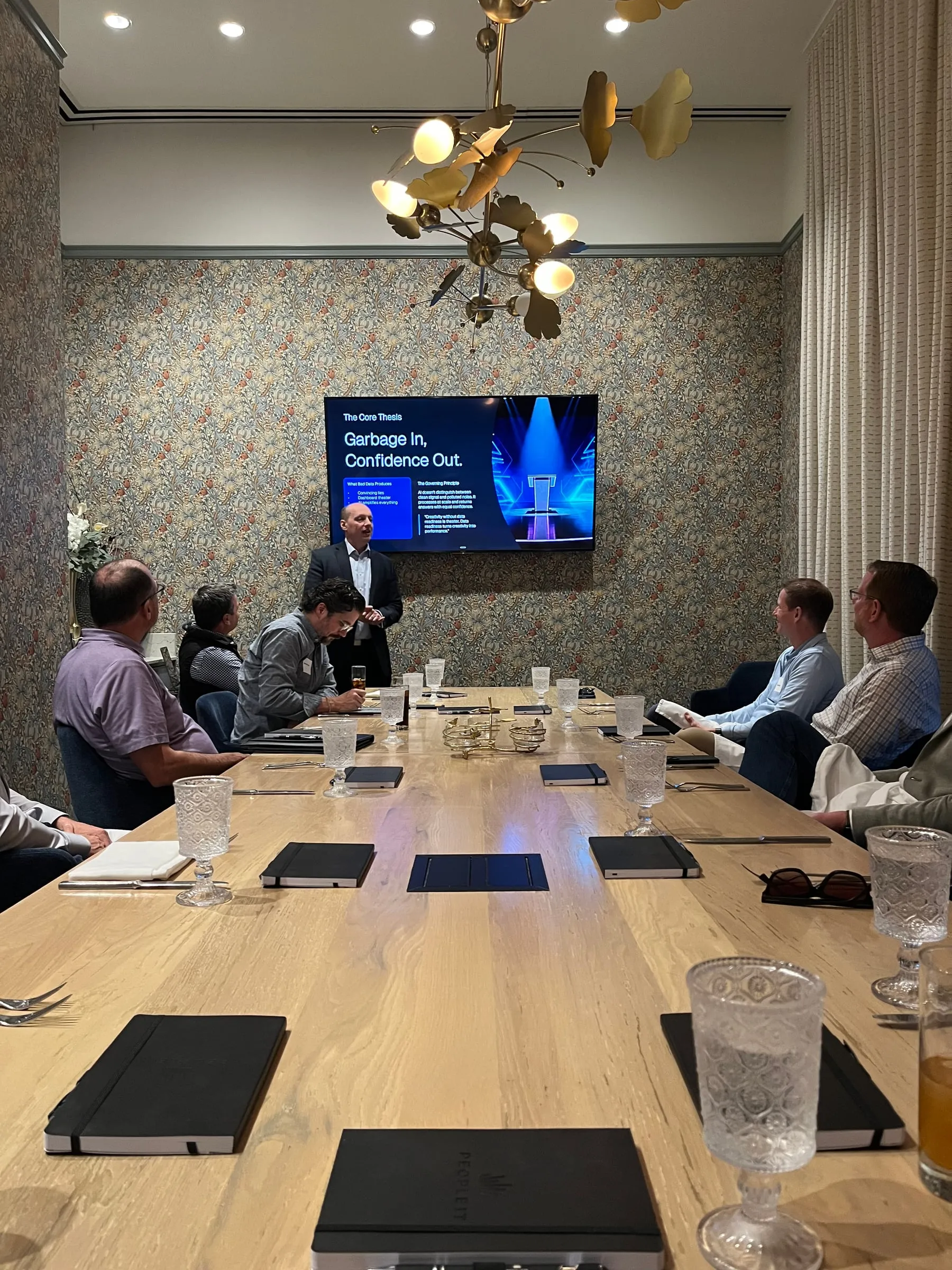 Yuriy Demidko presenting to executives at a PEOPLEIT lunch